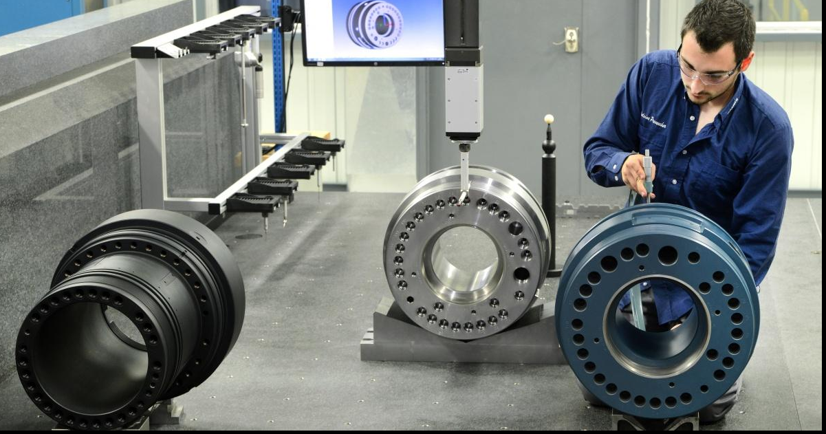Engineer performing dimensional inspection on machined components